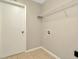 Laundry Room featuring tiled flooring, a storage shelf, and washer/dryer hookups at 10113 Tarragon Dr, Riverview, FL 33569