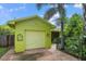 Charming single story home with a bright yellow exterior and lush landscaping at 1401 Bay Palm Blvd, Indian Rocks Beach, FL 33785