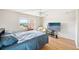 Bright bedroom with a large TV and water views at 1120 N Shore Ne Dr # 903, St Petersburg, FL 33701