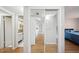 Hallway with mirrored closet doors and hardwood floors at 1120 N Shore Ne Dr # 903, St Petersburg, FL 33701