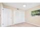 Bedroom featuring closet with sliding doors, new flooring, and a ceiling fan at 1978 Rebecca Dr, Clearwater, FL 33764