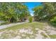 Single-story home with a green lawn and mature trees enhancing the curb appeal at 1978 Rebecca Dr, Clearwater, FL 33764