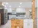 Open kitchen layout featuring a wooden island, stainless steel appliances, and granite countertops at 1978 Rebecca Dr, Clearwater, FL 33764