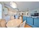 Bright dining area with hardwood floors, chandelier, and views of the living room and kitchen at 1359 Emerald Dunes Dr, Sun City Center, FL 33573