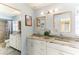 Modern bathroom with double vanity and large mirror at 33 Harbor Woods Cir, Safety Harbor, FL 34695