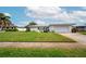 Front view of a white house with a green lawn at 14542 Anchorage Cir, Seminole, FL 33776