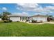 White house exterior with yellow chairs at 14542 Anchorage Cir, Seminole, FL 33776