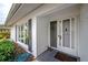 Front entrance of a single story home with white walls and grey shutters at 14542 Anchorage Cir, Seminole, FL 33776