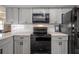 Close-up of kitchen range and microwave at 14542 Anchorage Cir, Seminole, FL 33776