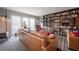 Bright living room featuring large windows, leather sofas, and a built-in bookcase at 14542 Anchorage Cir, Seminole, FL 33776