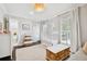 Bright Bedroom featuring a white crib, wood floors, neutral walls and a large window with plantation shutters at 2527 W Maryland Ave # A, Tampa, FL 33629