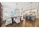 Open-concept dining area that flows into a modern kitchen with white cabinets at 2527 W Maryland Ave # A, Tampa, FL 33629