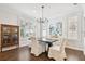 Bright dining room with hardwood floors, shutters, and a modern chandelier at 2527 W Maryland Ave # A, Tampa, FL 33629