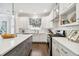 Bright, white kitchen with stainless steel appliances and view of floral valance at 2527 W Maryland Ave # A, Tampa, FL 33629