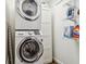 Bright laundry room with a stacked washer and dryer and shelving at 2527 W Maryland Ave # A, Tampa, FL 33629