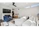 Bright living room featuring a white fireplace, a blue chair, and a comfortable white sofa at 2527 W Maryland Ave # A, Tampa, FL 33629