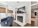 Cozy living room features a fireplace, a comfortable armchair, and natural light from large windows at 2527 W Maryland Ave # A, Tampa, FL 33629