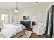 Lovely main bedroom featuring a chandelier, accent chair and hardwood floors at 2527 W Maryland Ave # A, Tampa, FL 33629