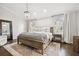 Bright main bedroom features a wood bed frame, dark hardwood floors and stylish chandelier at 2527 W Maryland Ave # A, Tampa, FL 33629