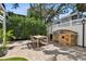 Outdoor patio featuring a dining table and a built-in stone grill, perfect for entertaining guests at 2527 W Maryland Ave # A, Tampa, FL 33629