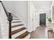 Hallway and staircase featuring hardwood floors and classic white trim at 2527 W Maryland Ave # A, Tampa, FL 33629