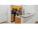 Well-equipped kitchen, featuring wood cabinets and a breakfast bar at 4207 S Dale Mabry Hwy # 11109, Tampa, FL 33611