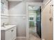 Clean bathroom with white vanity, shower stall, and view into laundry room at 455 13Th Ne Ave, St Petersburg, FL 33701