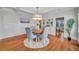 Light-filled dining area with hardwood floors, built-in shelving, and a round wooden table with blue chairs at 455 13Th Ne Ave, St Petersburg, FL 33701