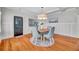 Bright dining room features hardwood floors, wainscoting, and a charming round table with four chairs at 455 13Th Ne Ave, St Petersburg, FL 33701