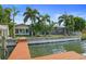 Private dock, pool, and lush tropical landscaping highlight this waterfront oasis at 613 79Th S Cir, St Petersburg, FL 33707