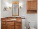 Bathroom features wood cabinets and granite countertop at 613 79Th S Cir, St Petersburg, FL 33707