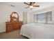 Spacious bedroom with bay window, ceiling fan, and ample dresser space at 613 79Th S Cir, St Petersburg, FL 33707