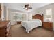 Comfortable bedroom with bay window, ceiling fan and wood furniture at 613 79Th S Cir, St Petersburg, FL 33707