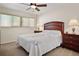 Spacious bedroom with ceiling fan and large windows at 613 79Th S Cir, St Petersburg, FL 33707