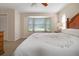 Bright bedroom with bay window, ceiling fan and carpeted floor at 613 79Th S Cir, St Petersburg, FL 33707