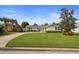 Single-story home with well-maintained lawn and circular driveway at 613 79Th S Cir, St Petersburg, FL 33707