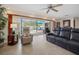 Spacious living room with pool view, recliner, and leather couches at 613 79Th S Cir, St Petersburg, FL 33707