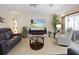 Living room featuring a large TV, recliner, and glass coffee table at 613 79Th S Cir, St Petersburg, FL 33707