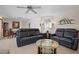 Living room with two leather reclining sofas and a glass coffee table at 613 79Th S Cir, St Petersburg, FL 33707