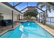 Relaxing screened pool and spa with patio furniture, offering beautiful water views at 613 79Th S Cir, St Petersburg, FL 33707