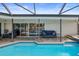 Covered patio with seating overlooking the pool at 613 79Th S Cir, St Petersburg, FL 33707