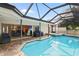 Stunning canal-front pool and spa with screened enclosure, offering serene views at 613 79Th S Cir, St Petersburg, FL 33707