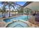 Resort-style pool and spa with patio furniture and water views at 613 79Th S Cir, St Petersburg, FL 33707