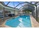 Inviting pool and spa with covered patio and lush landscaping at 613 79Th S Cir, St Petersburg, FL 33707