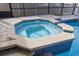 Octagonal spa adjacent to the pool at 613 79Th S Cir, St Petersburg, FL 33707