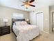 Bright bedroom with a queen-size bed, nightstands, and large closet at 504 Florida S Cir, Apollo Beach, FL 33572