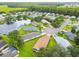 Aerial view of homes and community features, including a lake at 11609 Weaver Park Ct, Trinity, FL 34655