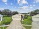 Single-story house with a two-car garage, and a well-maintained yard at 11609 Weaver Park Ct, Trinity, FL 34655