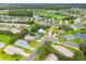 Aerial view of community with golf course and lake nearby at 11609 Weaver Park Ct, Trinity, FL 34655