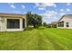 Landscaped backyard with lush lawn and trees at 11609 Weaver Park Ct, Trinity, FL 34655